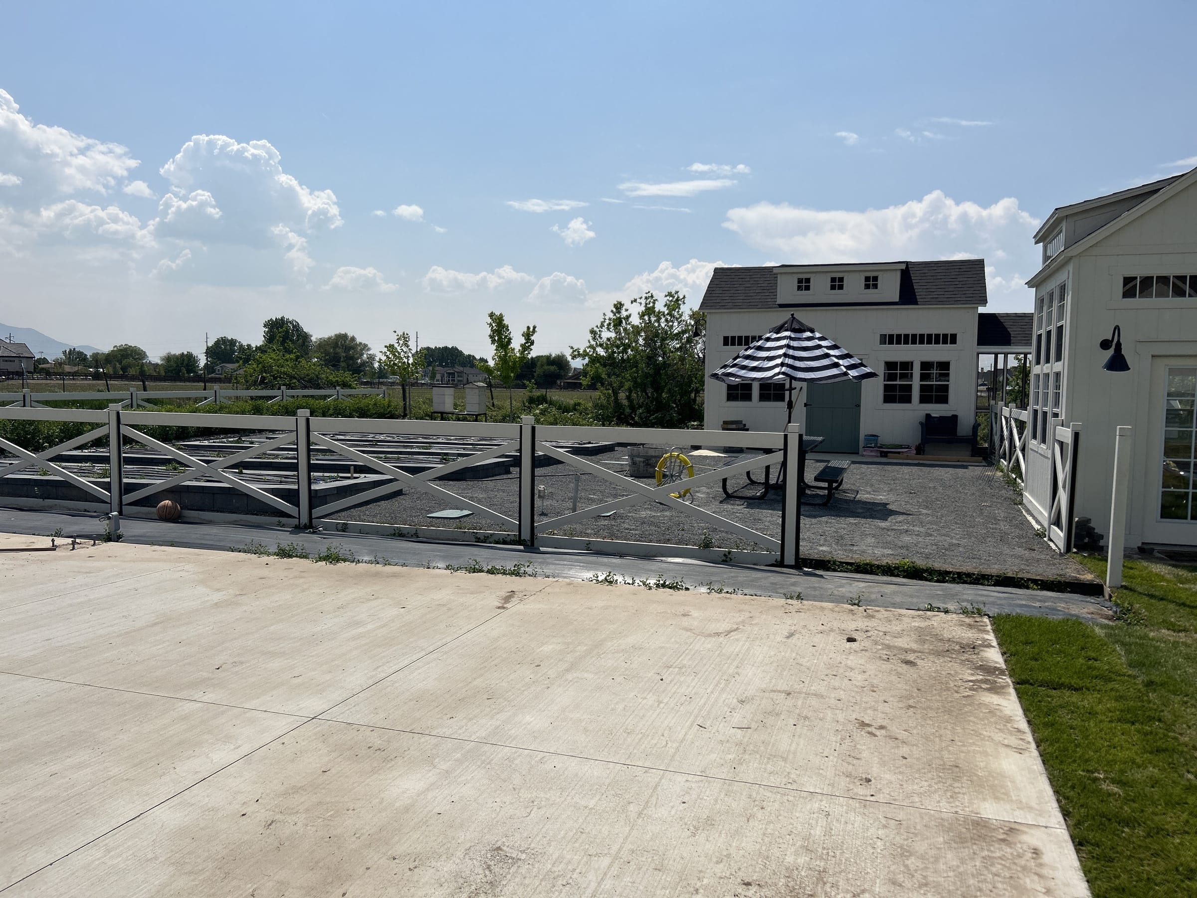 Large concrete patio and cross-buck fence