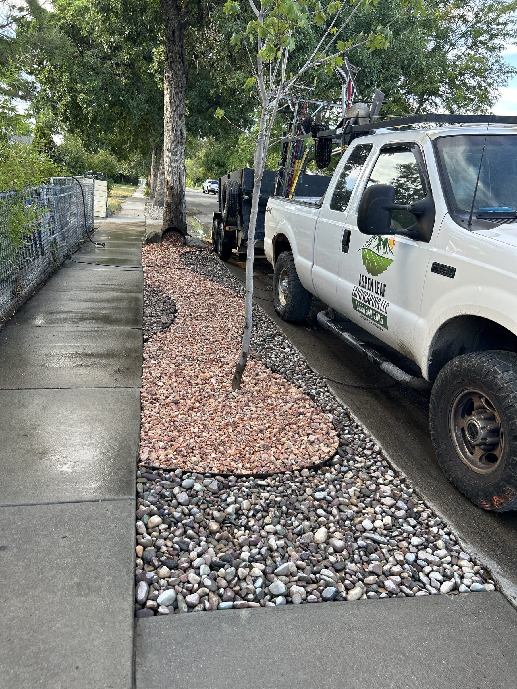 The Aspen Leaf company truck parked beside a finished rock park strip